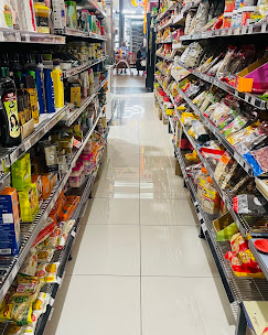 Grocery aisle stocked with Indian snacks and pantry staples